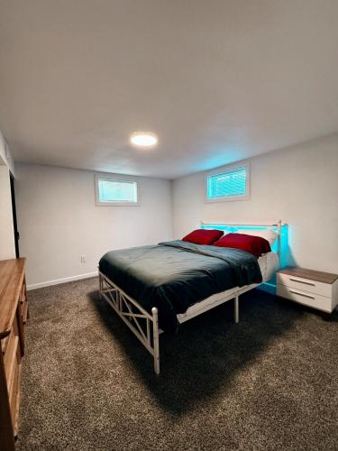 a bedroom with a bed with red pillows on it at Comfortable Family Getaway! in Cheyenne