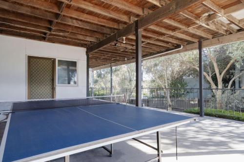 a ping pong table in the middle of a patio at Bayview Cottage - Serene Escape between Beach & Bay in Blairgowrie