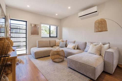 a living room with a couch and a table at Villa Morava - Dog-friendly Beachside Comfort in Rosebud