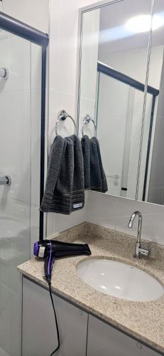 a bathroom counter with a sink and a mirror at Ap novo, perto de Congonhas, com cama queen size in São Paulo