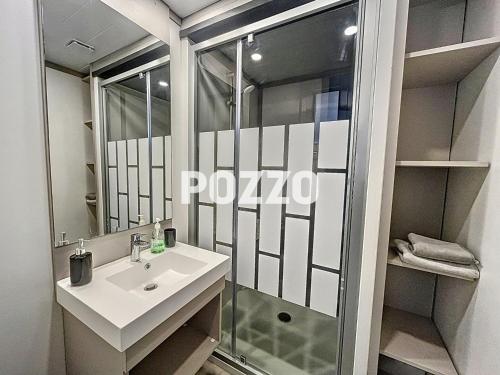 une salle de bain avec un lavabo et une douche dans l'établissement Chalet de standing à Jullouville - 6 couchages - FR-1-361-568, à Jullouville