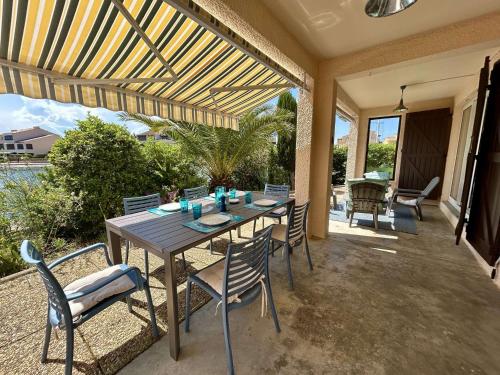 un patio avec une table et des chaises sur un patio dans l'établissement Appartement 3 pièces avec terrasse à Saint-Cyprien - FR-1-225D-225, à Saint-Cyprien