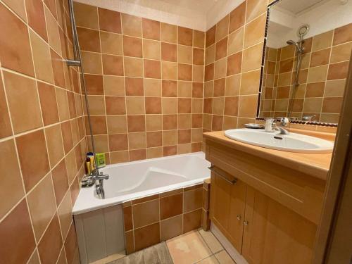 une salle de bain avec une baignoire et un lavabo dans l'établissement Studio cabine RDC proche plage avec parking privé - FR-1-328-276, à La Grande Motte