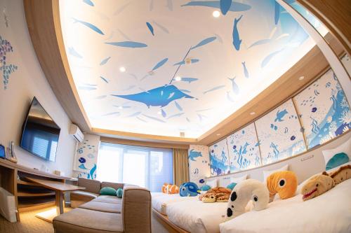 a room with two beds and a fish painting on the ceiling at GOLD STAY Nagoya Sakae ゴールドステイ名古屋栄 in Nagoya