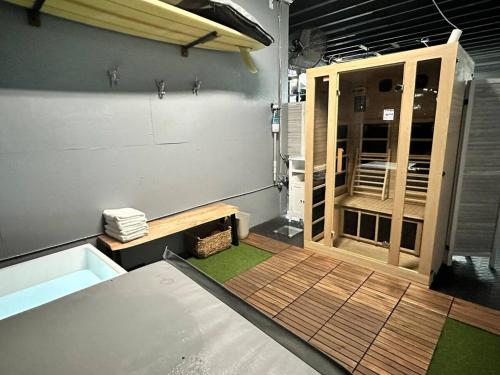 a room with a shower with a wooden door at The Bosun Locker at Seahorse Rentals in Jacksonville Beach