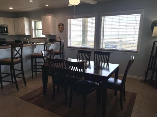 a dining room with a table and chairs in a kitchen at Beachgate Condo Suites and Hotel 531 condo in Port Aransas