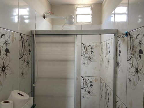 a bathroom with a shower with a glass door at Pousada BG Lençóis in Barreirinhas