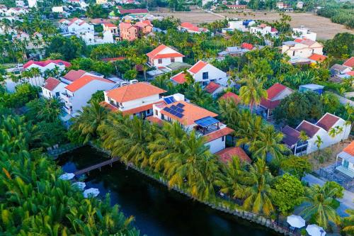 an aerial view of a village with palm trees and houses at Mayci Boutique Hotel & Restaurant by Amber in Hoi An
