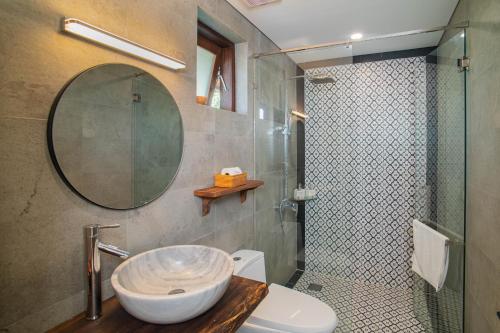 a bathroom with a sink and a shower and a toilet at Mayci Boutique Hotel & Restaurant by Amber in Hoi An
