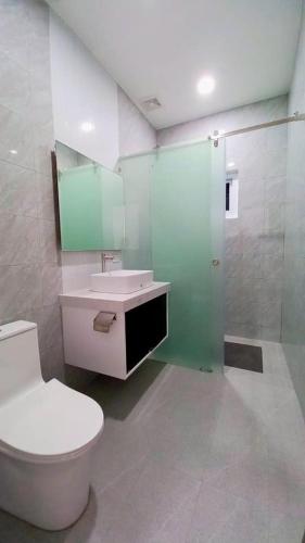 a bathroom with a toilet and a sink and a shower at Garden 7 Pool Villa in Sampong