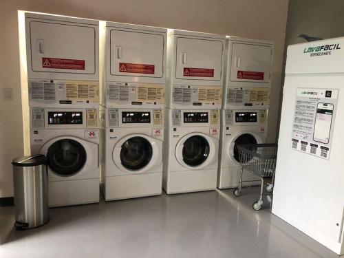 four washing machines are lined up in a room at Excellent location, beautiful apartment in San José