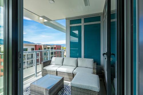 a balcony with a couch and a table at Beach Lake Resort in Kelowna