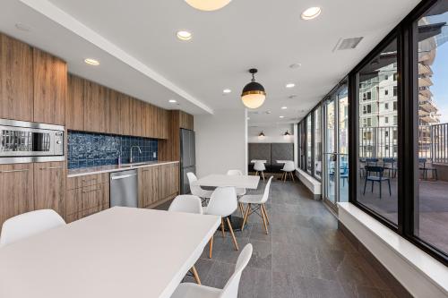 an office with white tables and chairs and windows at Beach Lake Resort in Kelowna