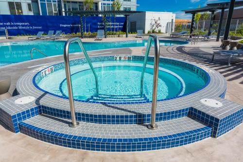 a swimming pool with blue tiles around it at Beach Lake Resort in Kelowna