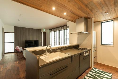 a kitchen with a sink and some windows at MOVA VILLA Koshi Daiwa 3 in Yuge