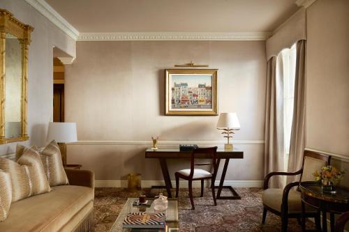 a living room with a table and a couch and a desk at Egerton House in London