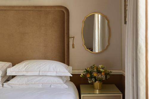 a bedroom with a bed and a mirror on the wall at Egerton House in London