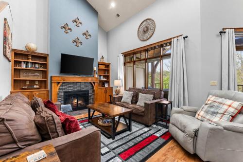 a living room with a couch and a fireplace at Penthouse Eagle View - for 12 in Branson