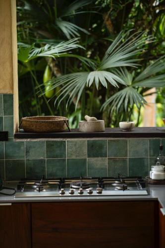 a kitchen stove with a green tiled counter top at Casa Adobe Finca in La Peña