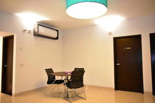 a room with a table and chairs and a television at Spring Hill Hotel and Service Apartments in Dhaka