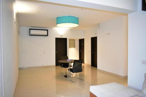 a dining room with a table and chairs in a room at Spring Hill Hotel and Service Apartments in Dhaka