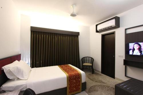 a bedroom with a bed and a tv in it at Spring Hill Hotel and Service Apartments in Dhaka