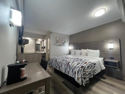 a hotel room with a bed and a bathroom at Red Roof Inn Lexington South in Lexington