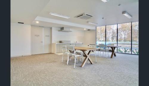 an office with two tables and chairs in a room at Capri on Flinders in Rockingham