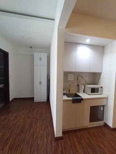 a kitchen with a microwave and a counter top at K Avenue by Pinstay in Donggongon