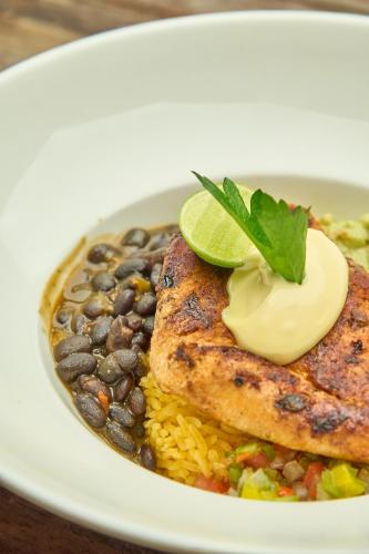 a plate of food with black beans and rice at Community Hostel Quito in Quito