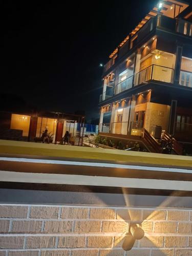 a building on the side of a street at night at Little Hearts in Chennai