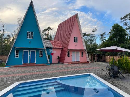 a house with a swimming pool in front of it at WIWI Village in Kemasik