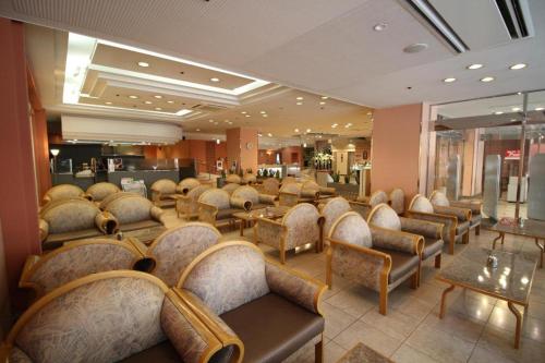 a salon with chairs and a waiting room at Oita Century Hotel in Oita