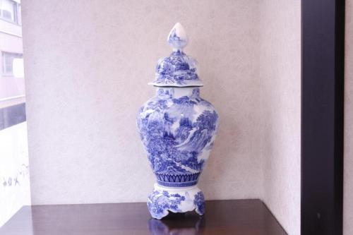 a blue and white vase sitting on a table at Oita Century Hotel in Oita