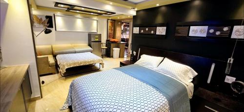 a bedroom with a bed and a couch in it at RH #4 los ángeles, elegant suite 2nd floor in San Juan