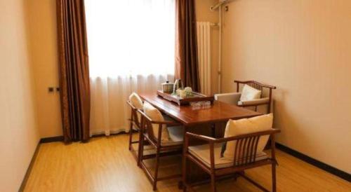 a dining room with a table and chairs and a window at 7 Days Premium Beijing Dabaotai Metro Station Luhua Road in Beijing