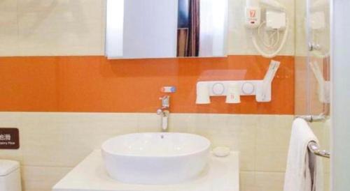 a bathroom with a white sink and a mirror at 7 Days Premium Beijing Dabaotai Metro Station Luhua Road in Beijing