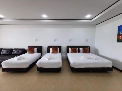 a room with two beds and a couch at C View Home in Nan