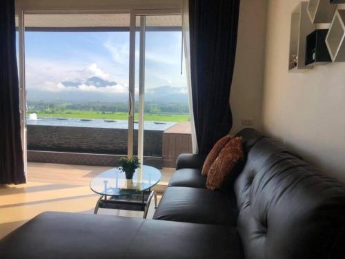 a living room with a leather couch and a glass table at C View Home in Nan