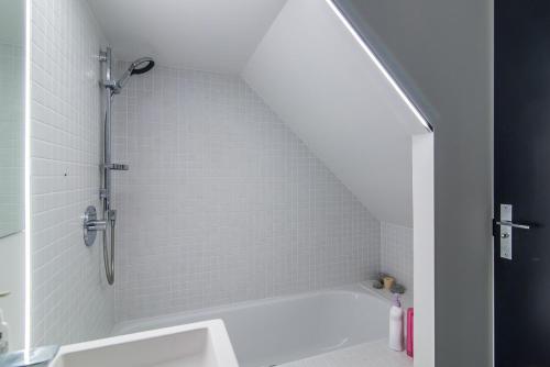 a bathroom with a shower and a white tub at Luxury Wellington Accomodation in Wellington