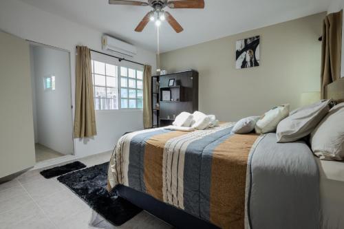 a bedroom with a bed and a ceiling fan at BnB rooms in downtown Cancun- Casa Sunshine Cancun in Cancún