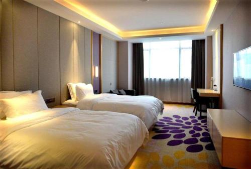 Letto o letti in una camera di Lavande Hotel·Yichun Wanda, High Speed Railway Station