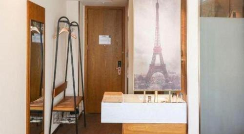 a room with a view of the eiffel tower at James Joyce Coffetel Changchun People's Square in Changchun