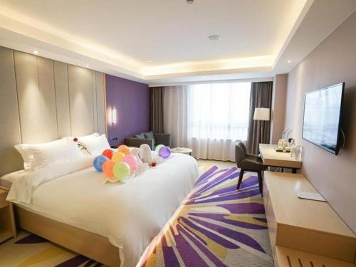 a hotel room with a bed with balloons on it at Lavande Hotels· Suizhou Wenfeng in Suizhou
