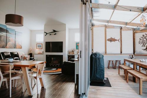 a living room with a table and a dining room at Serenity - Space for Everyone in St Helens