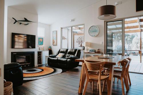 a living room with a table and a fireplace at Serenity - Space for Everyone in St Helens