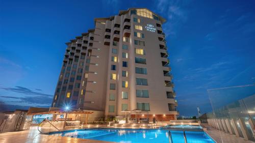 a hotel with a pool in front of a building at Crowne Plaza Santo Domingo by IHG in Santo Domingo