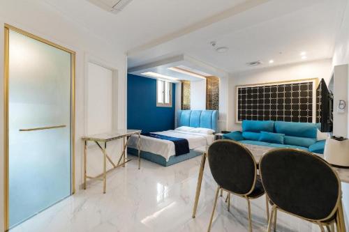 a bedroom with a bed and a table and chairs at The Bay hotel & pool villa in Suncheon