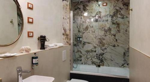 a bathroom with a shower with a toilet and a sink at OYO Huifeng Business Hotel in Lanzhou