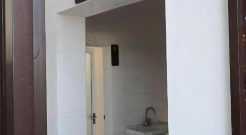 a bathroom with a toilet and a sink at OYO Huifeng Business Hotel in Lanzhou